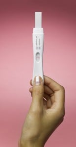 Woman's hand holding pregnancy test